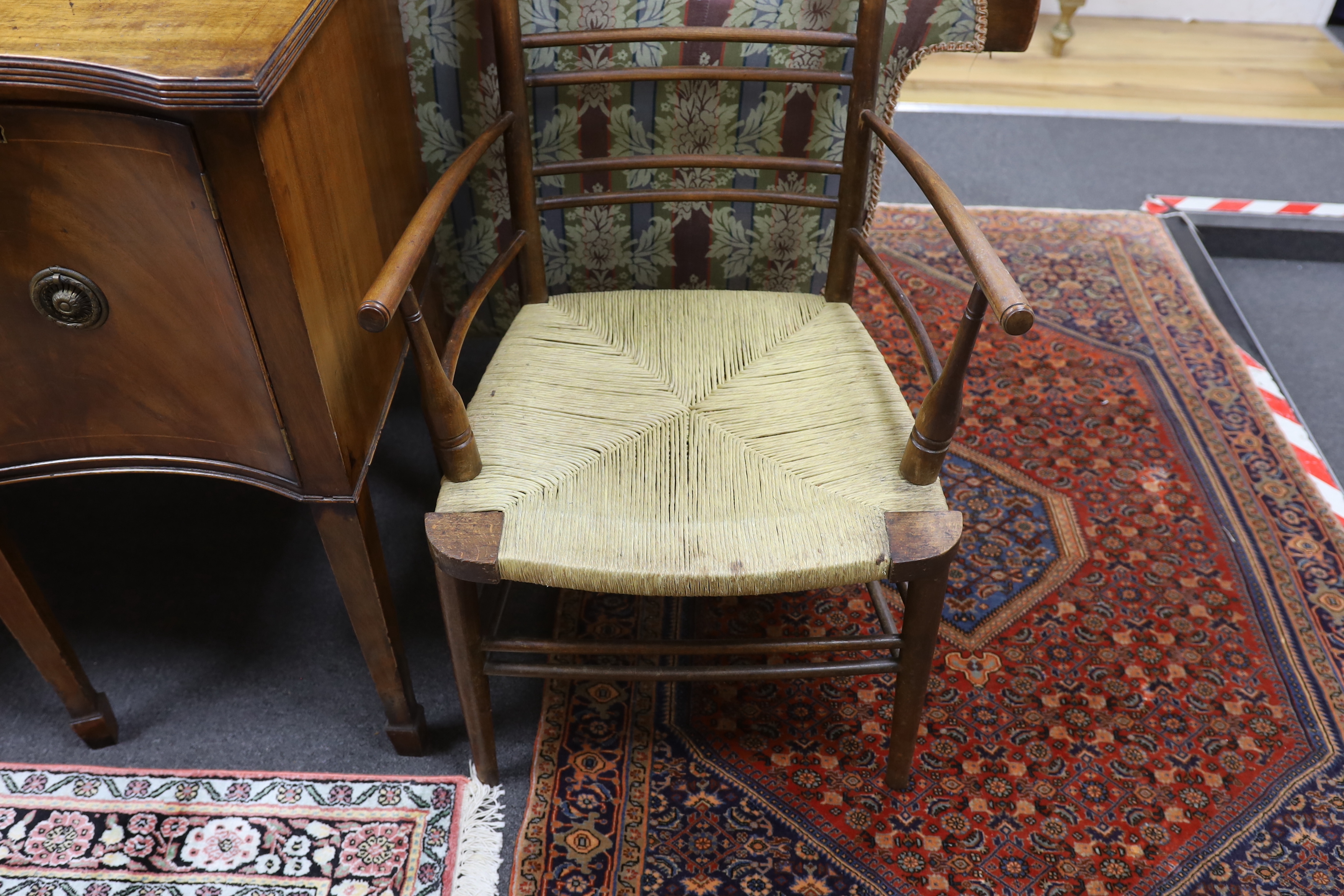 A William Morris style beech and fruitwood rush seated elbow chair
